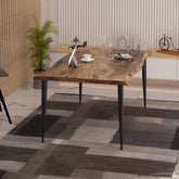 La table à manger Velets Lia, plateau en MDF et pieds fuselés