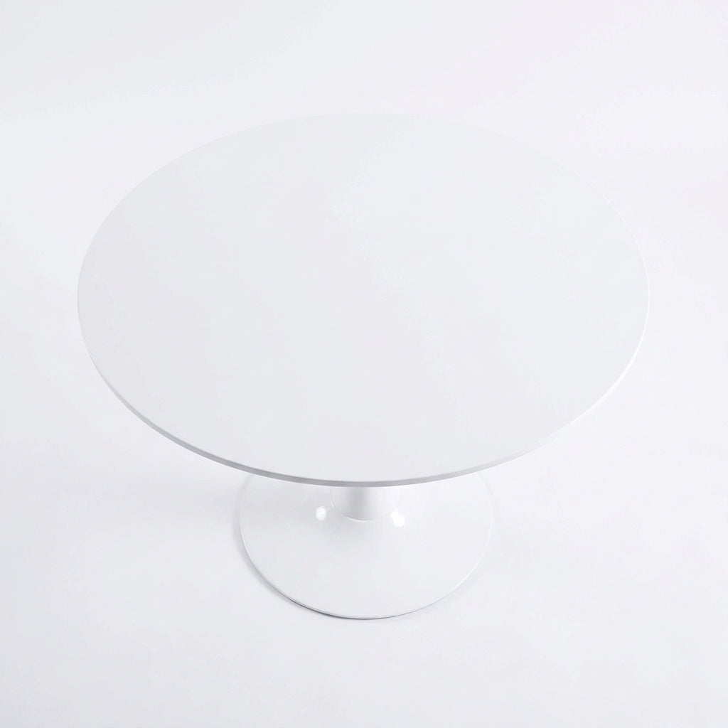 Angled top view of the round white tabletop of the Velets 40 inch tulip dining table