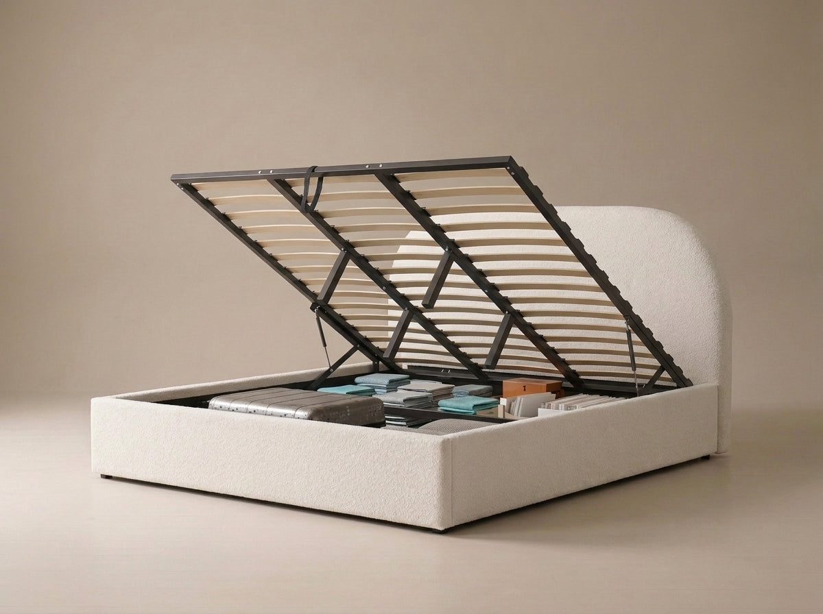 Velets Flora boucle upholstered bed with lift-up storage open and items stored underneath.
